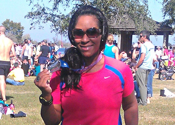 Cherie shows off the bling she scored after her first half marathon.
