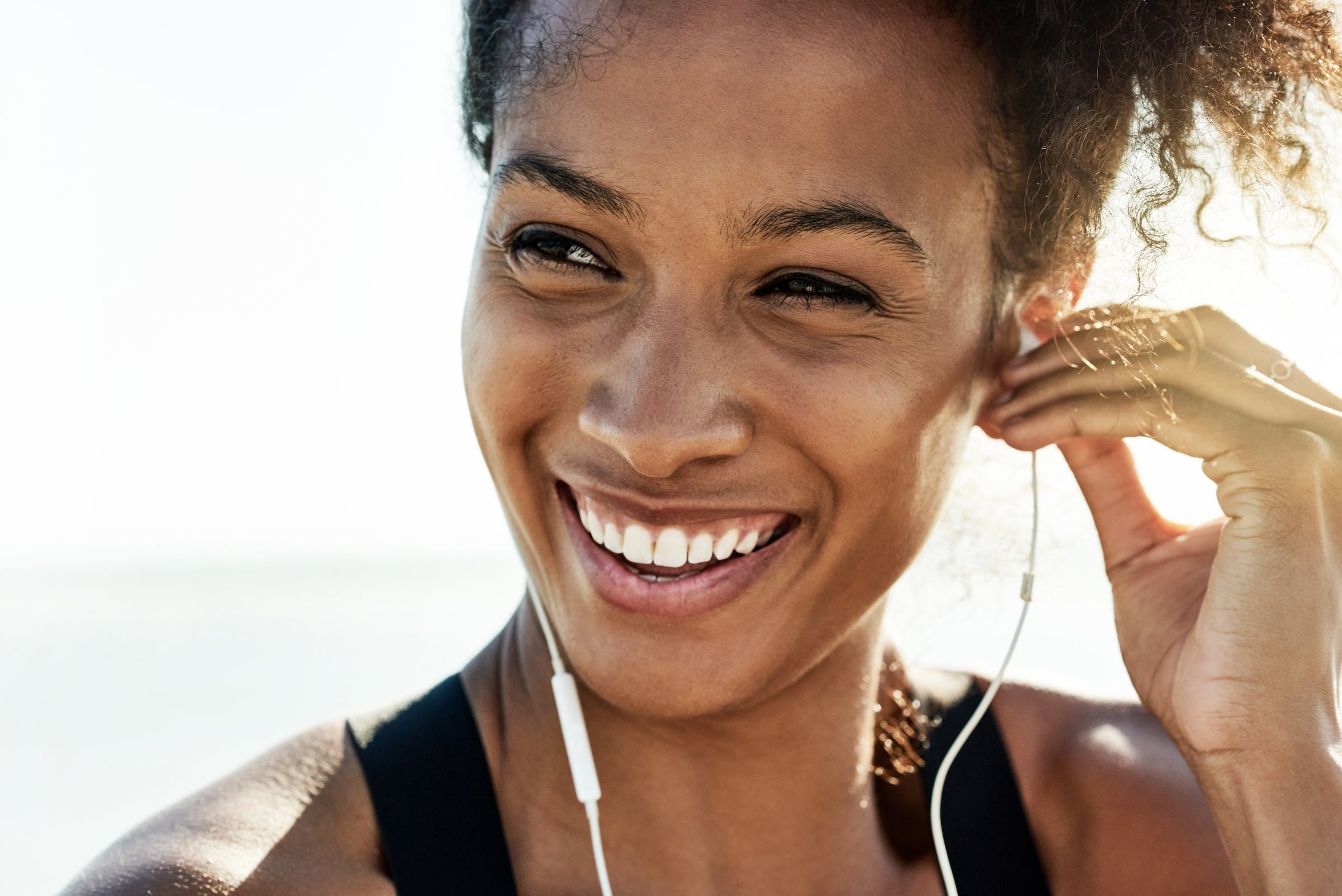 Shot of a fit young woman working out at the beach