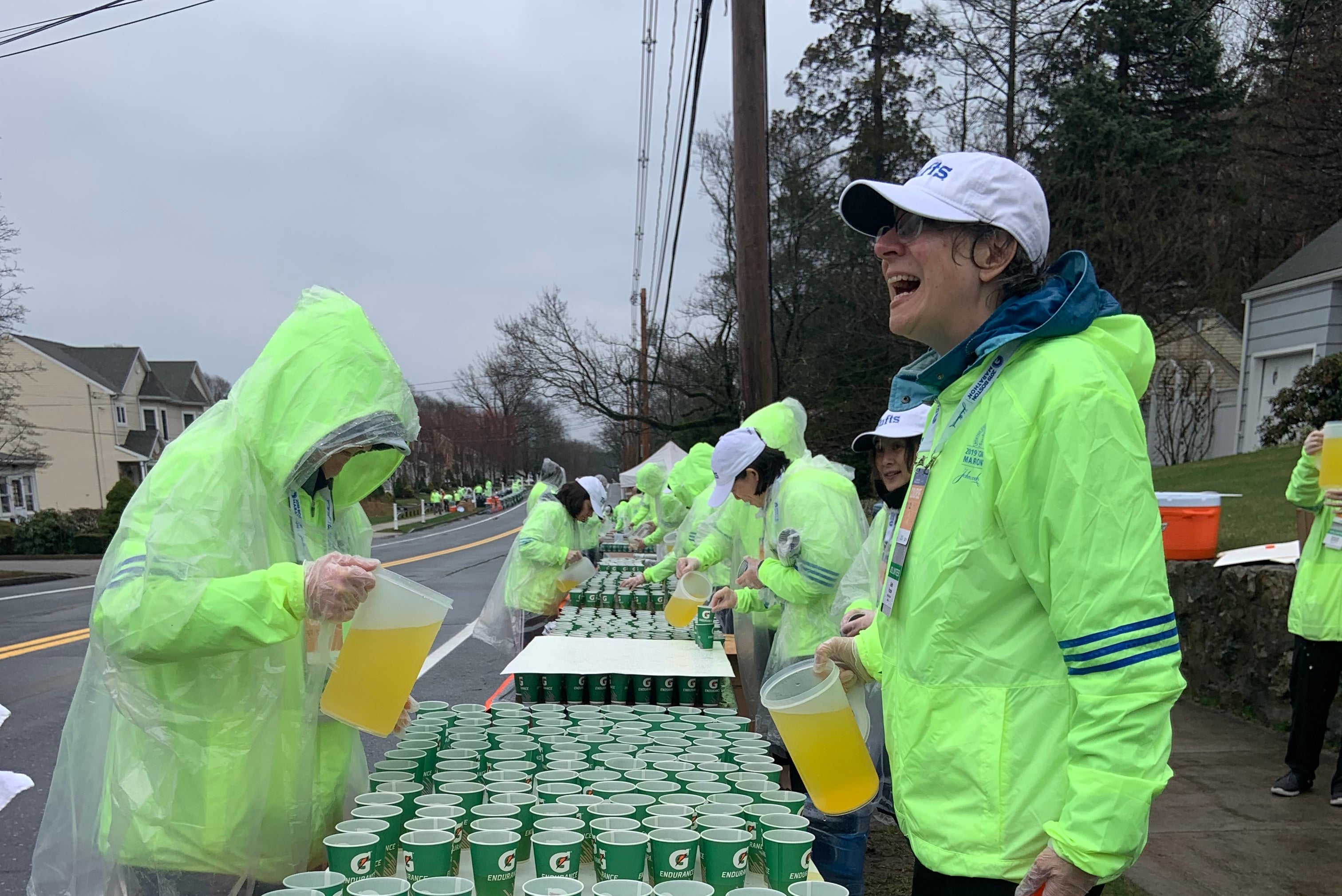 PHOTO: B.A.A./Alaina Belanger
Volunteers pour sports drinks at an aid station before the 2019 Boston Marathon.