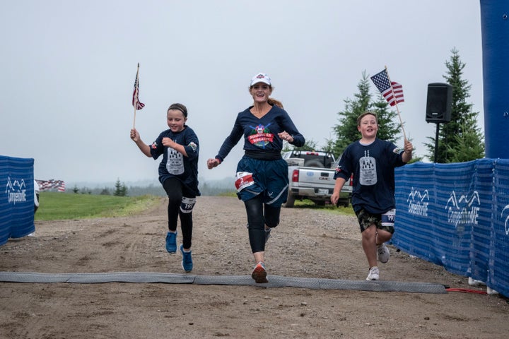 Wreaths Across America Cathy Powers runs with the two grandchildren of Wreaths Across America founders, Miles and Lola.
