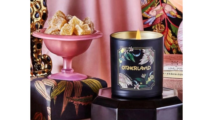 Candle next to pink candy dish