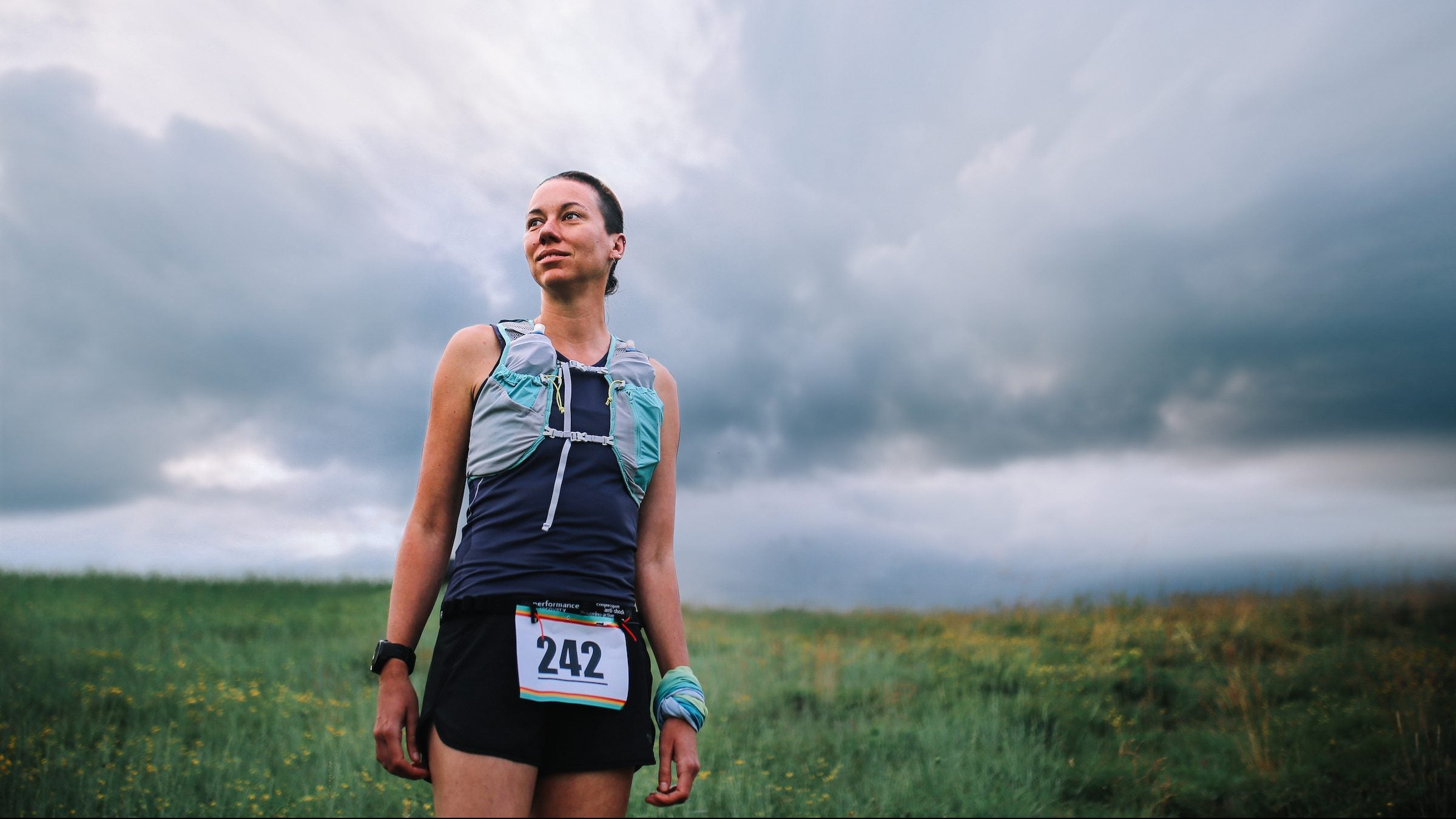 Female runner standing after a 50K race in nature