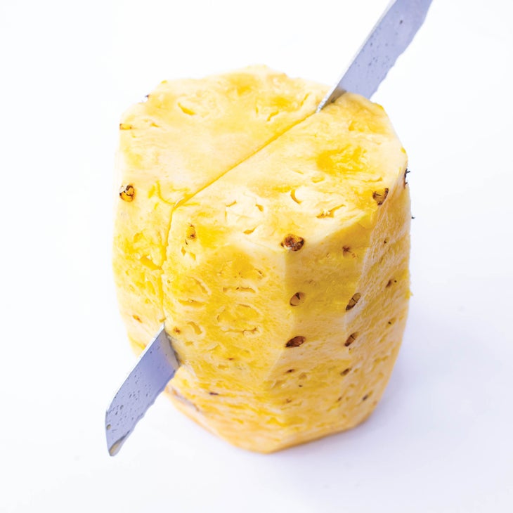 Halving a pineapple