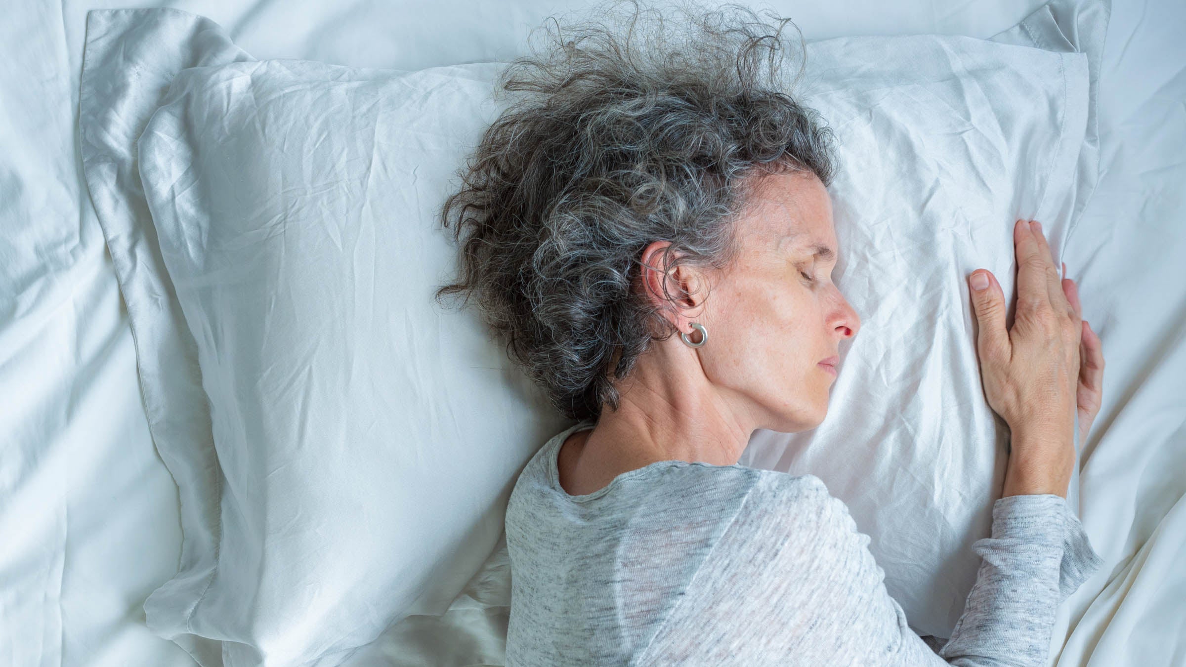 Woman Sleeping On Bed