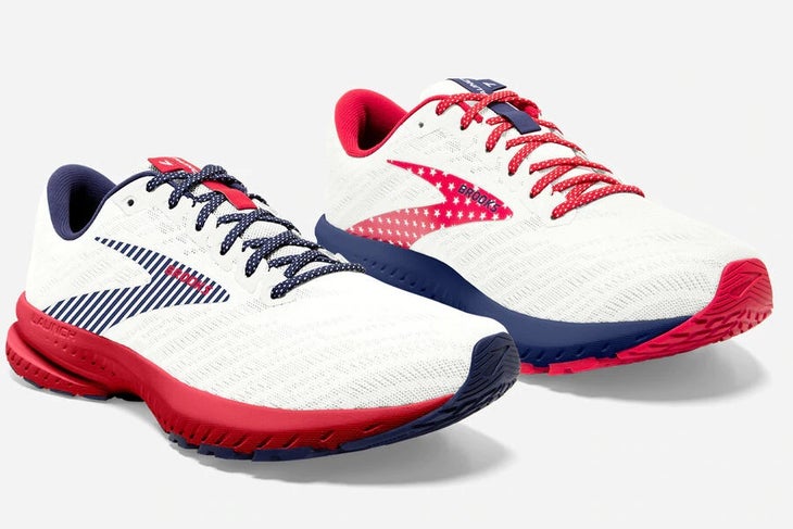 White running shoes with red and blue soles and laces