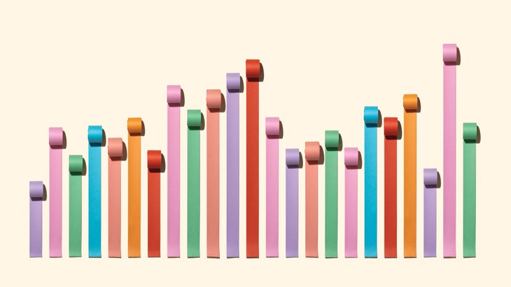 Chaos Bar Chart Made of Paper Rolls on Solid Beige Background.