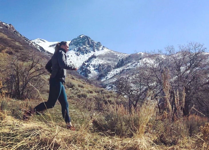 Lauren Wilke, a COVID long hauler, running in the mountains