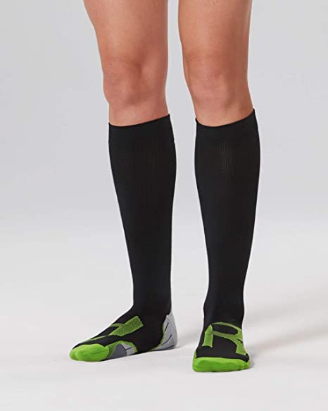 woman wearing a pair of 2XU knee-high black compression recovery socks