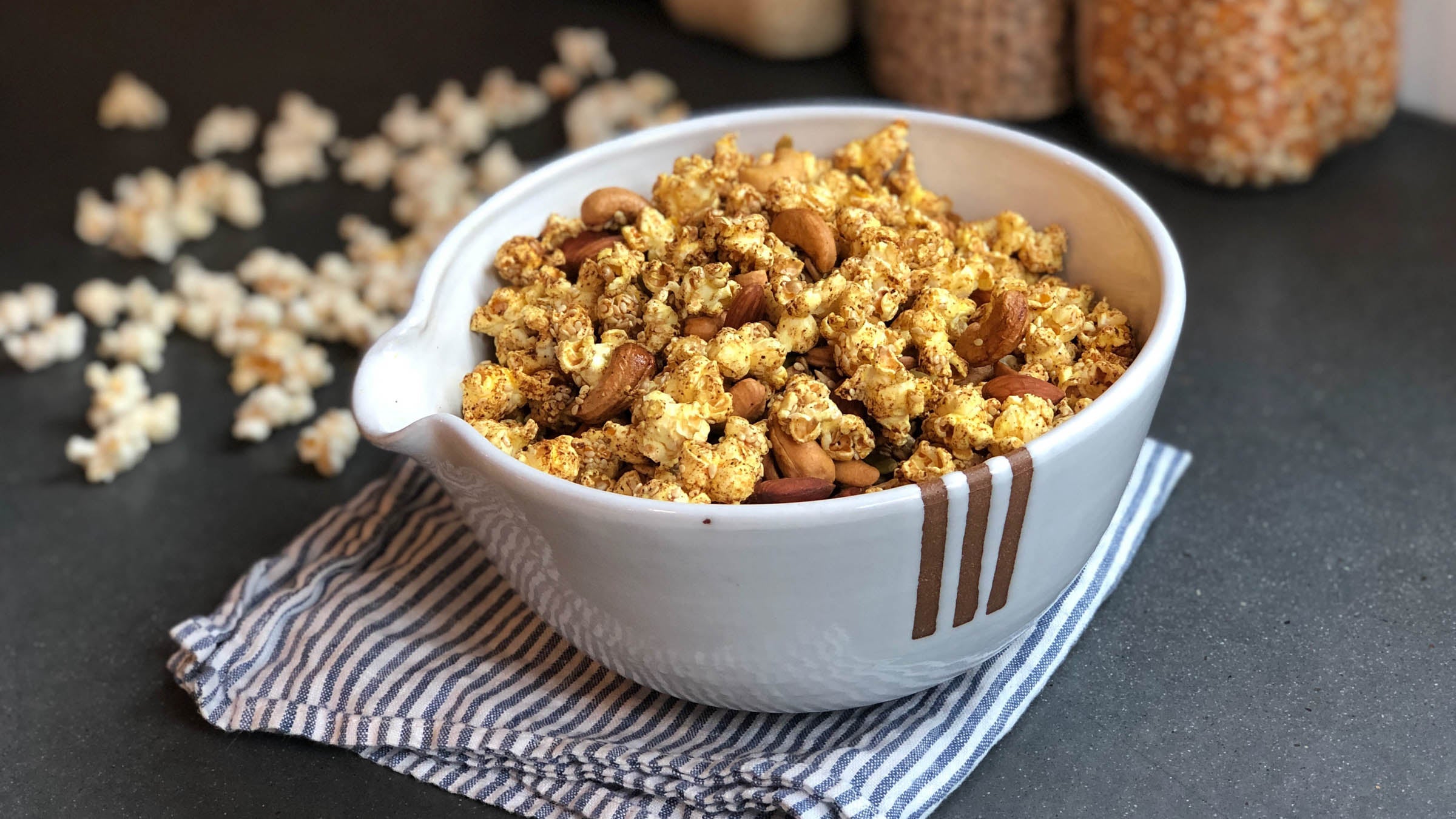 Bowl of popcorn granola on a gray countertop