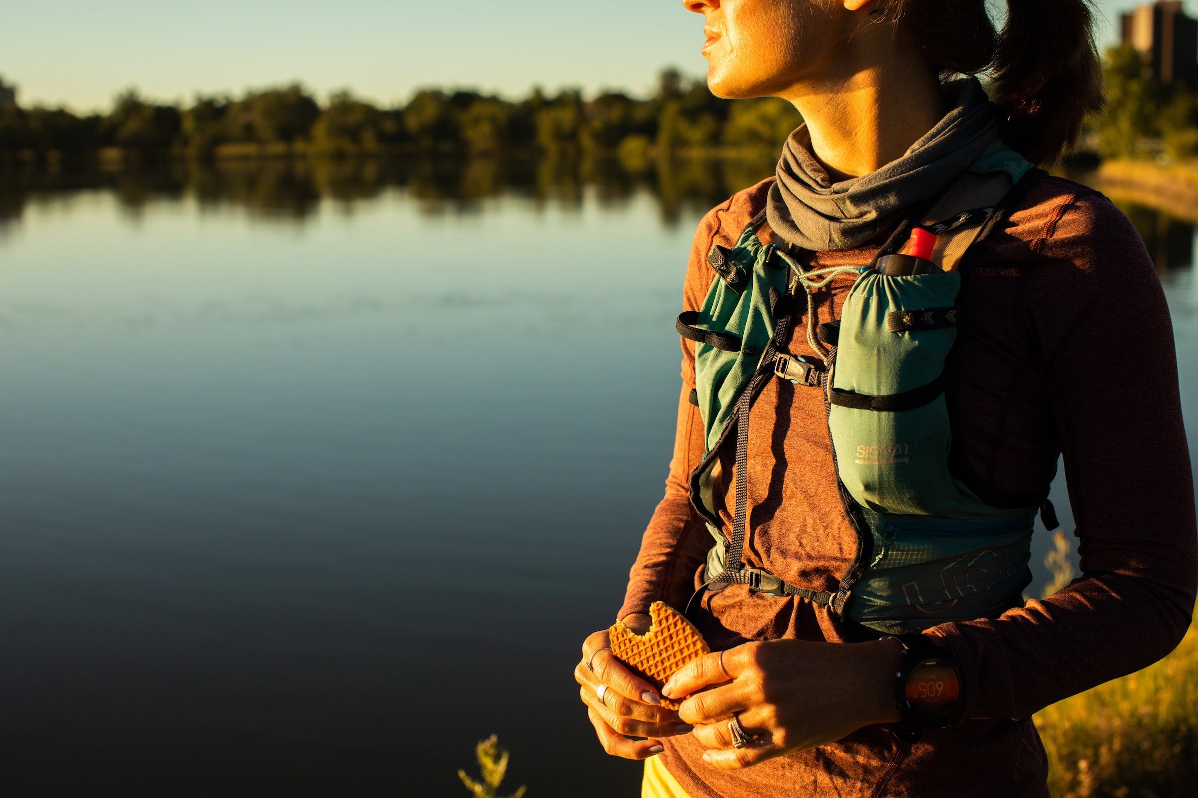 Woman taking break from trail run to eat a stroopwafel