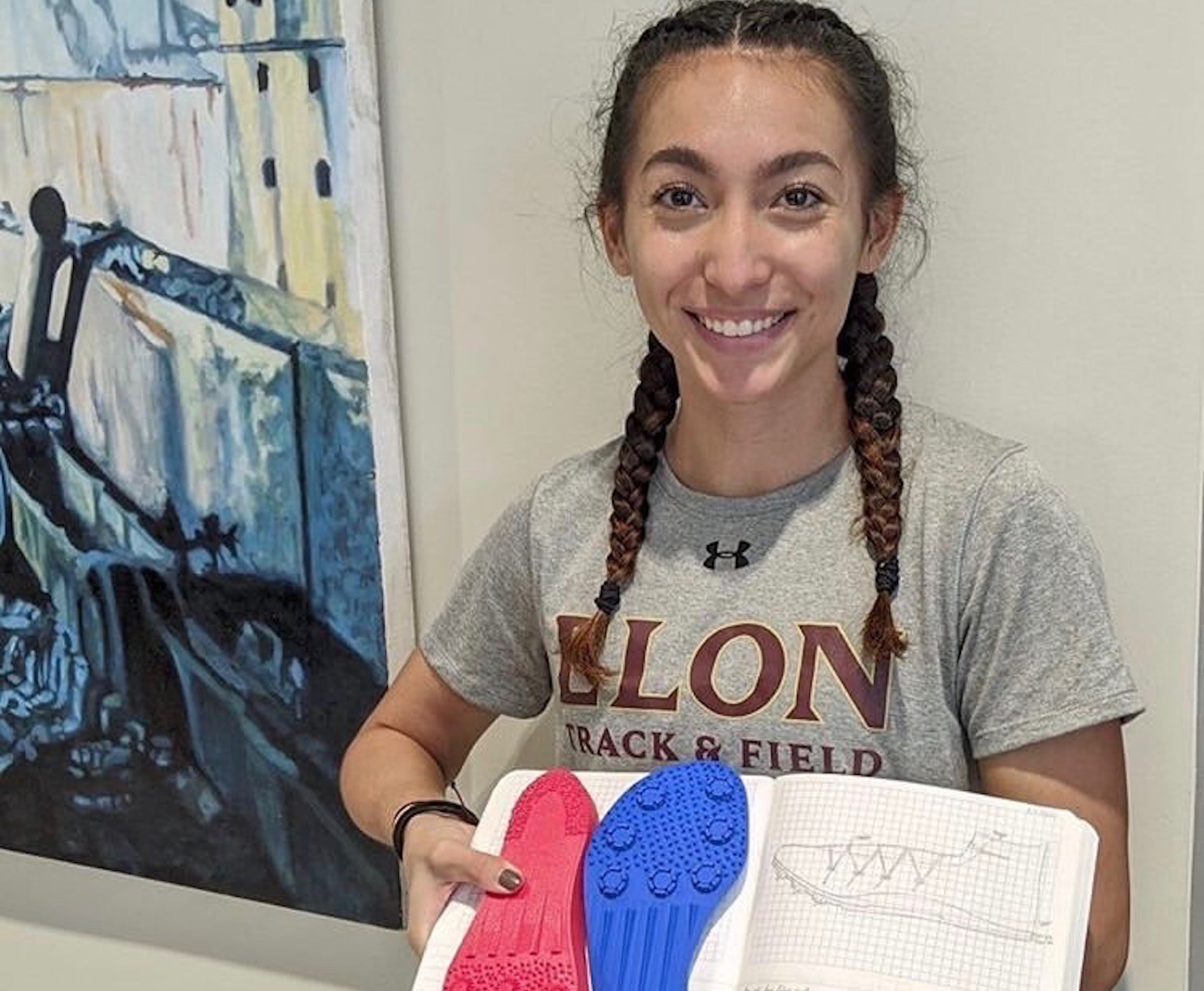 Madison George holding her women's pole vaulting shoe design.