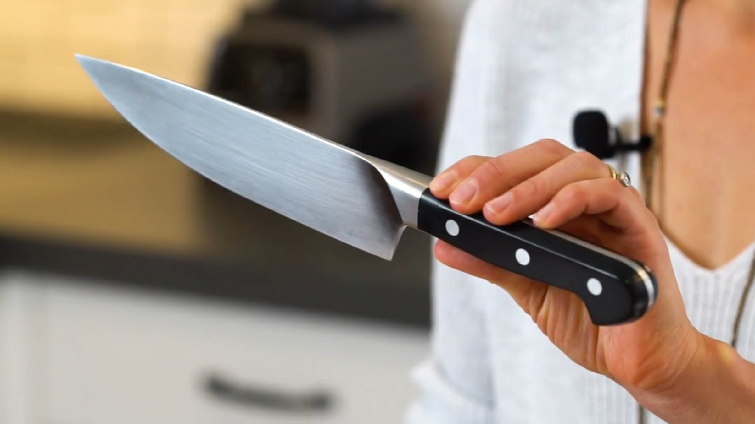 Elyse Kopecky holding up a chef's knife