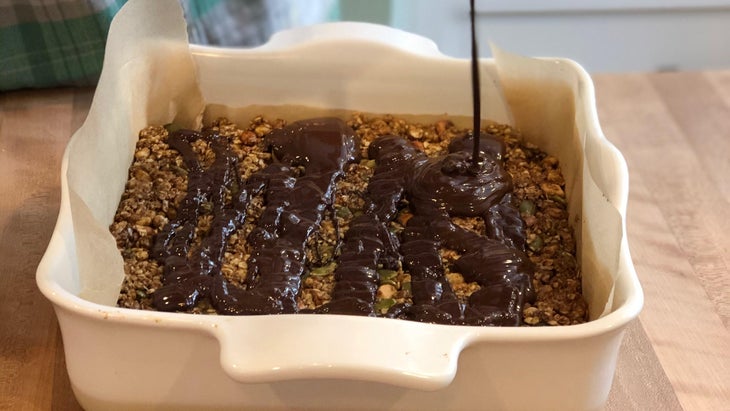 Melting chocolate over Elyse Kopecky's no-bake granola bars, a snack high in iron