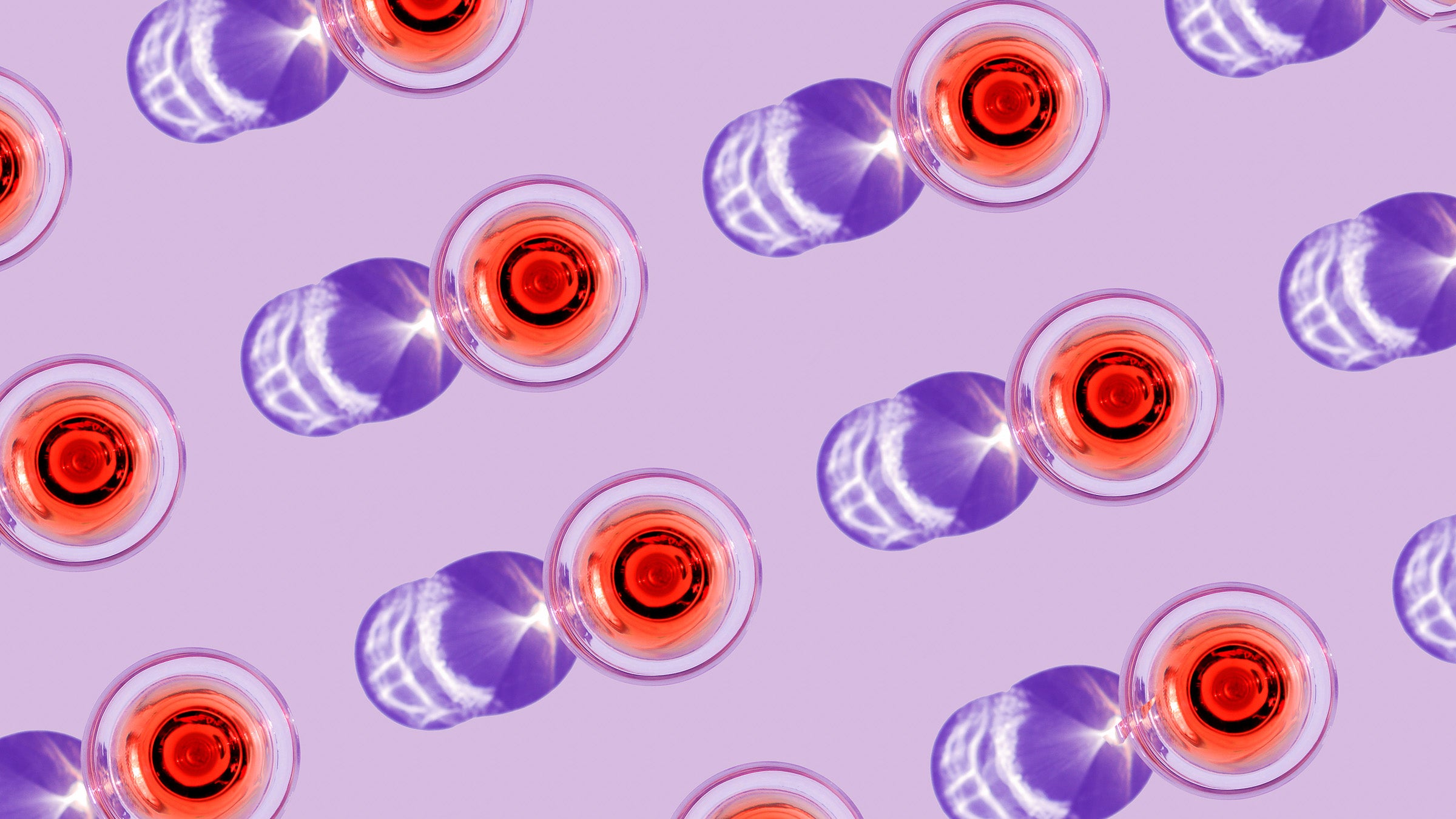 Pattern of glasses of redliqueur against pink background