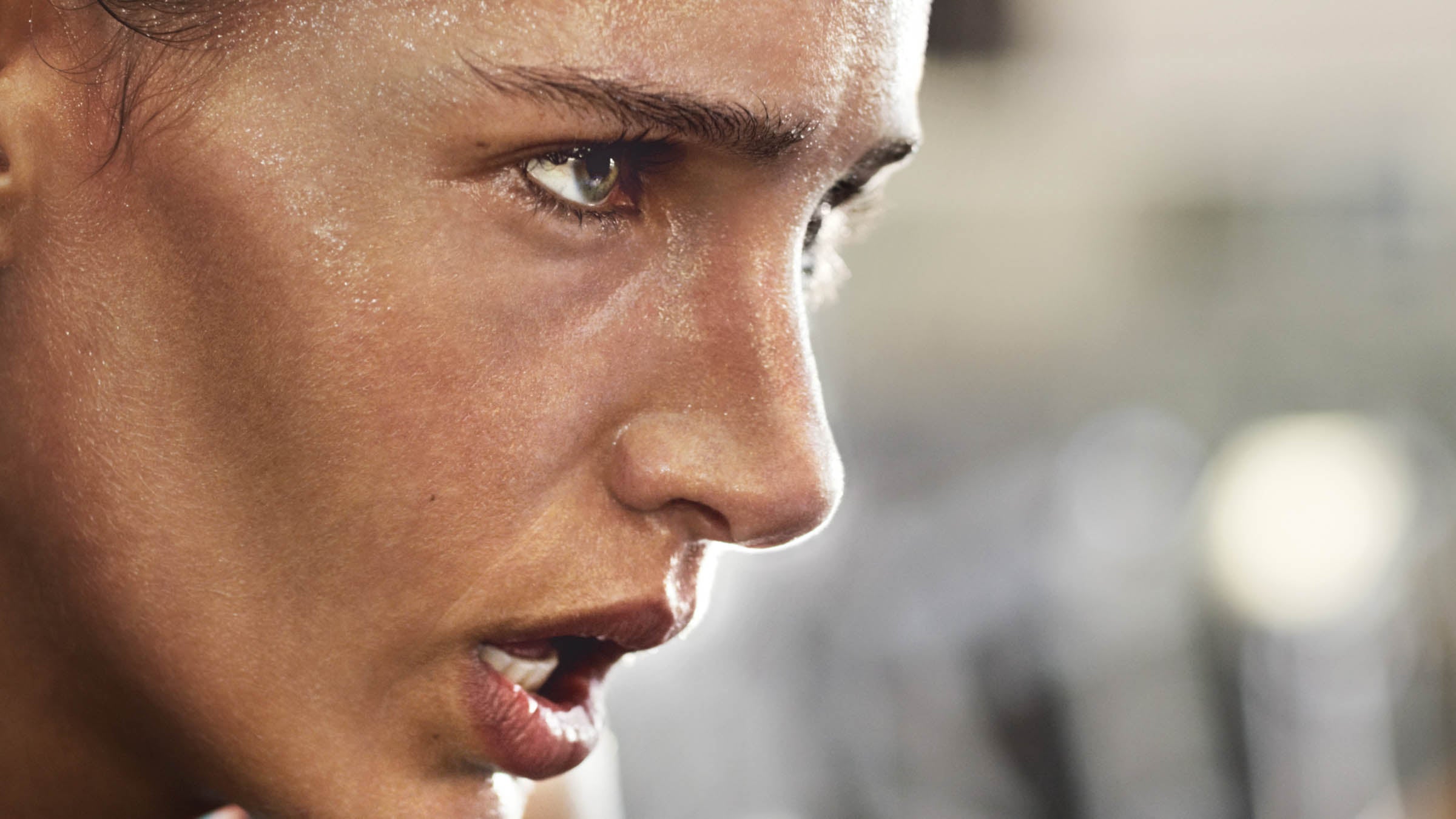 Cropped shot of a determined looking young woman working out in the gym