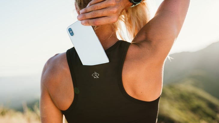 Woman using Rabbit Utilit bra-vo for her phone.