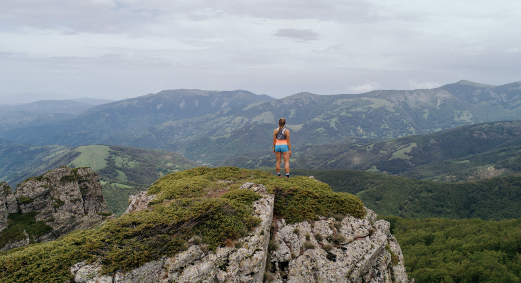 Addie Bracy standing on top of a mountain
