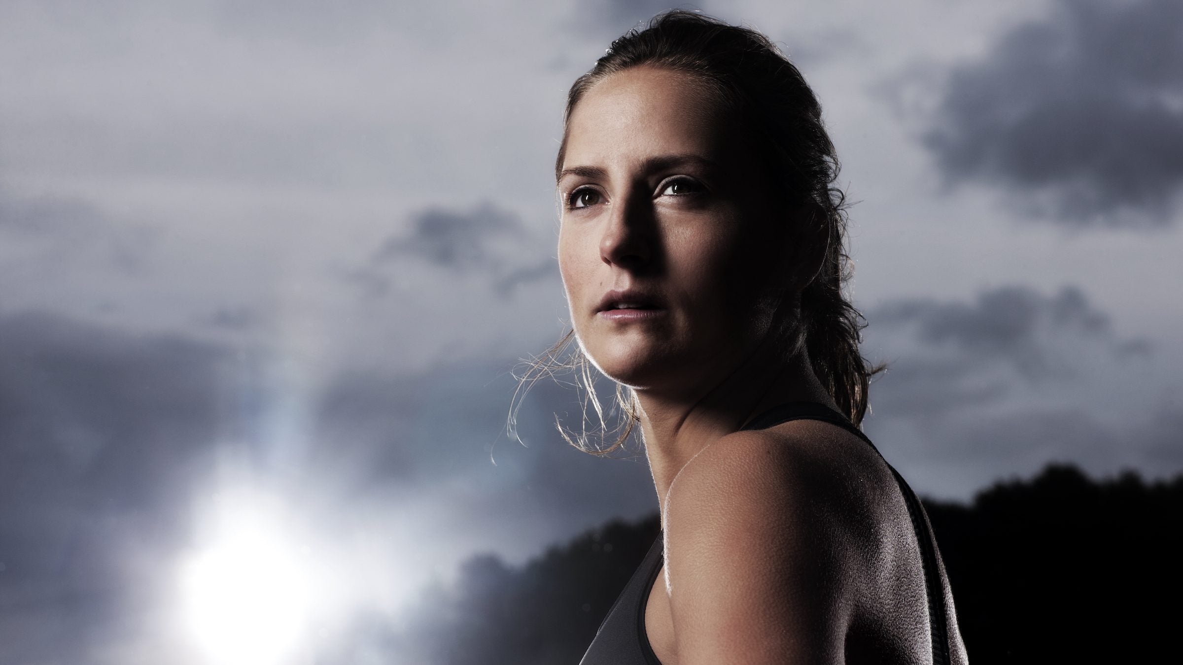 portrait of a woman on the track looking off into the distance