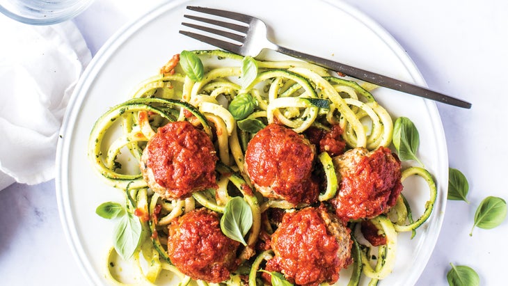 Plate of Herbed Chicken Meatball Marinara with Zoodles & Pesto is a gut-healthy recipe