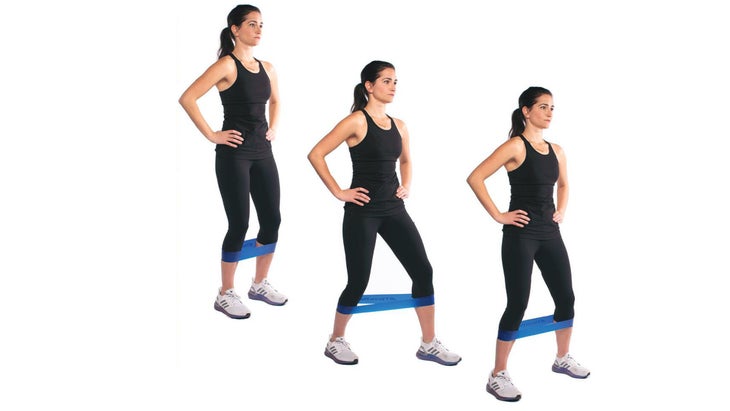 Woman demonstrating Monster Walks as part of a quick warm up