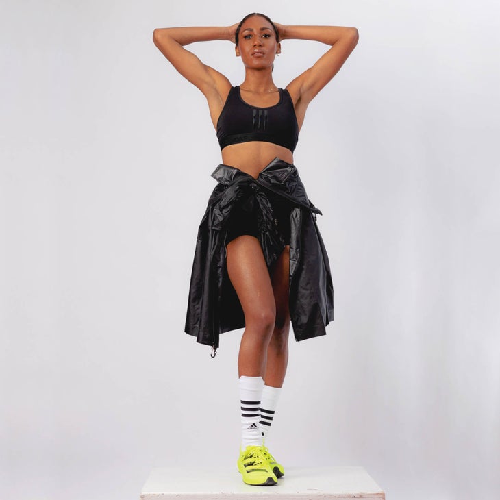 Ajee' Wilson posing on a white podium