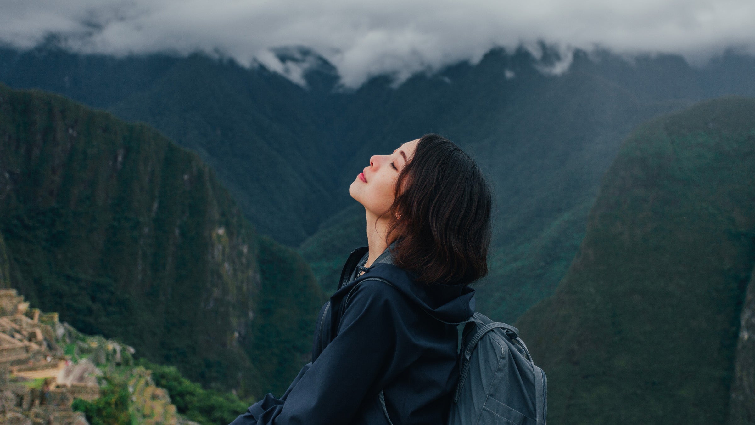 Young Woman Enjoying Fresh Air On A Mountain