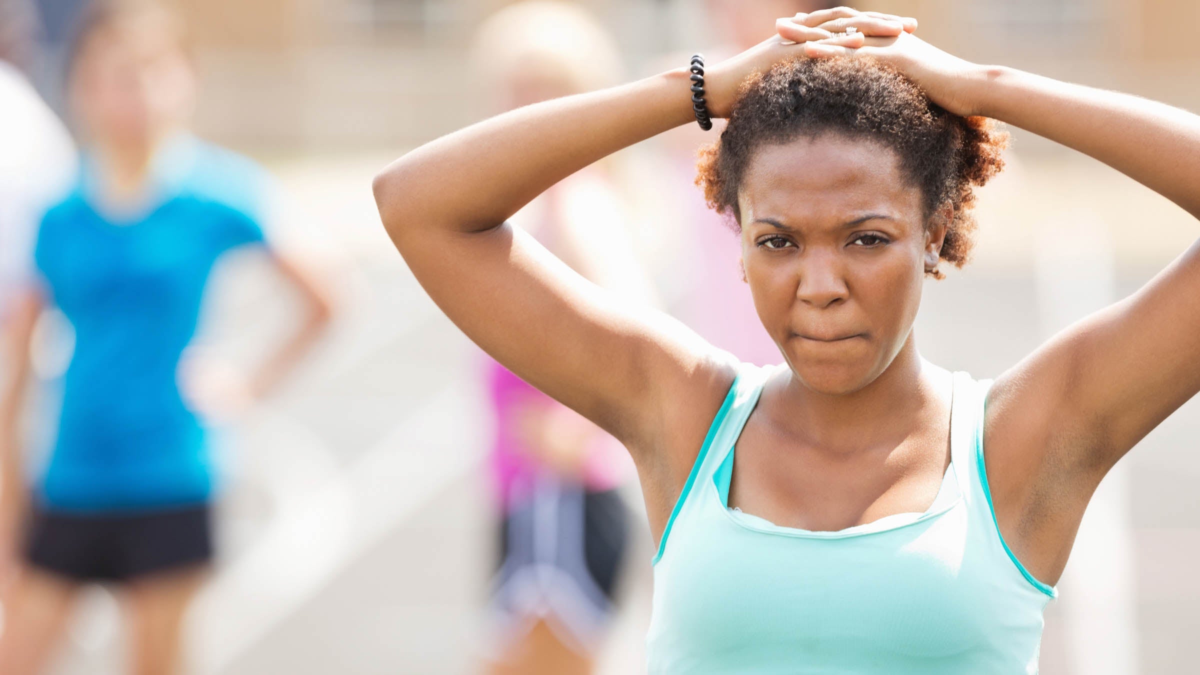 Athletic woman looking worried before a race