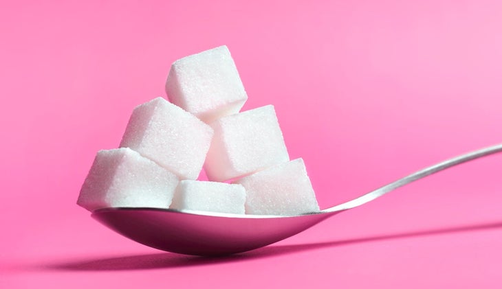 a spoon with squares of white sugar