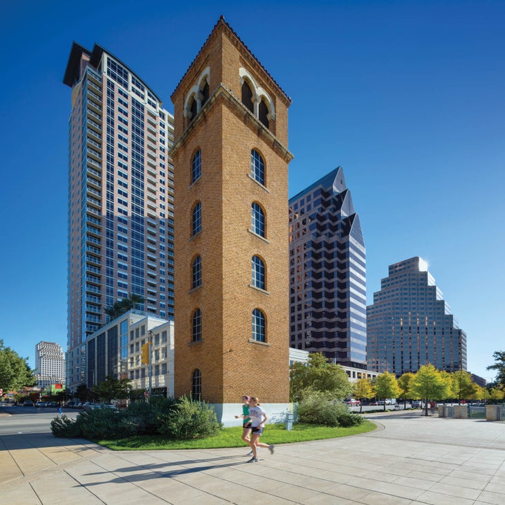 Two joggers run past Buford Tower in Austin, Texas.