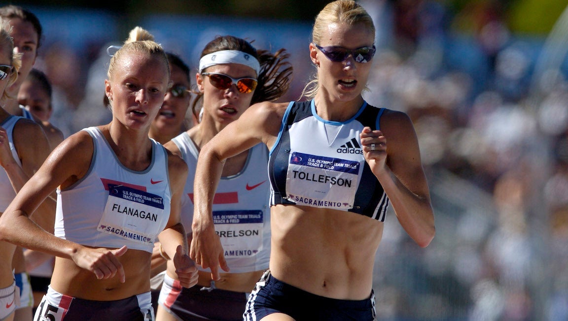 Three women running in a track race.