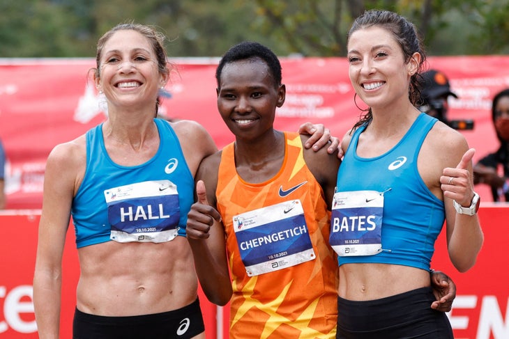 Emma Bates gives the thumbs up next to Ruth Chepngetich and Sara Hall