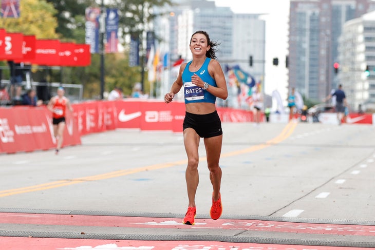 Emma Bates, runner, crosses finish line at the 2021 Chicago Marathon. One of Emma's marathon training tips is to stay calm and focused during the race