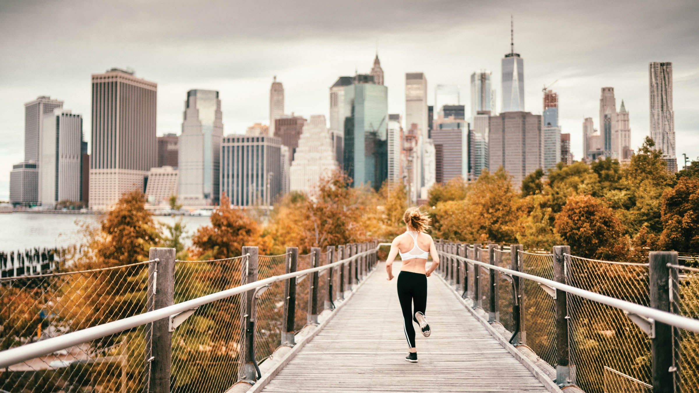 Woman Running in Brooklyn with views of Manhattan in the background