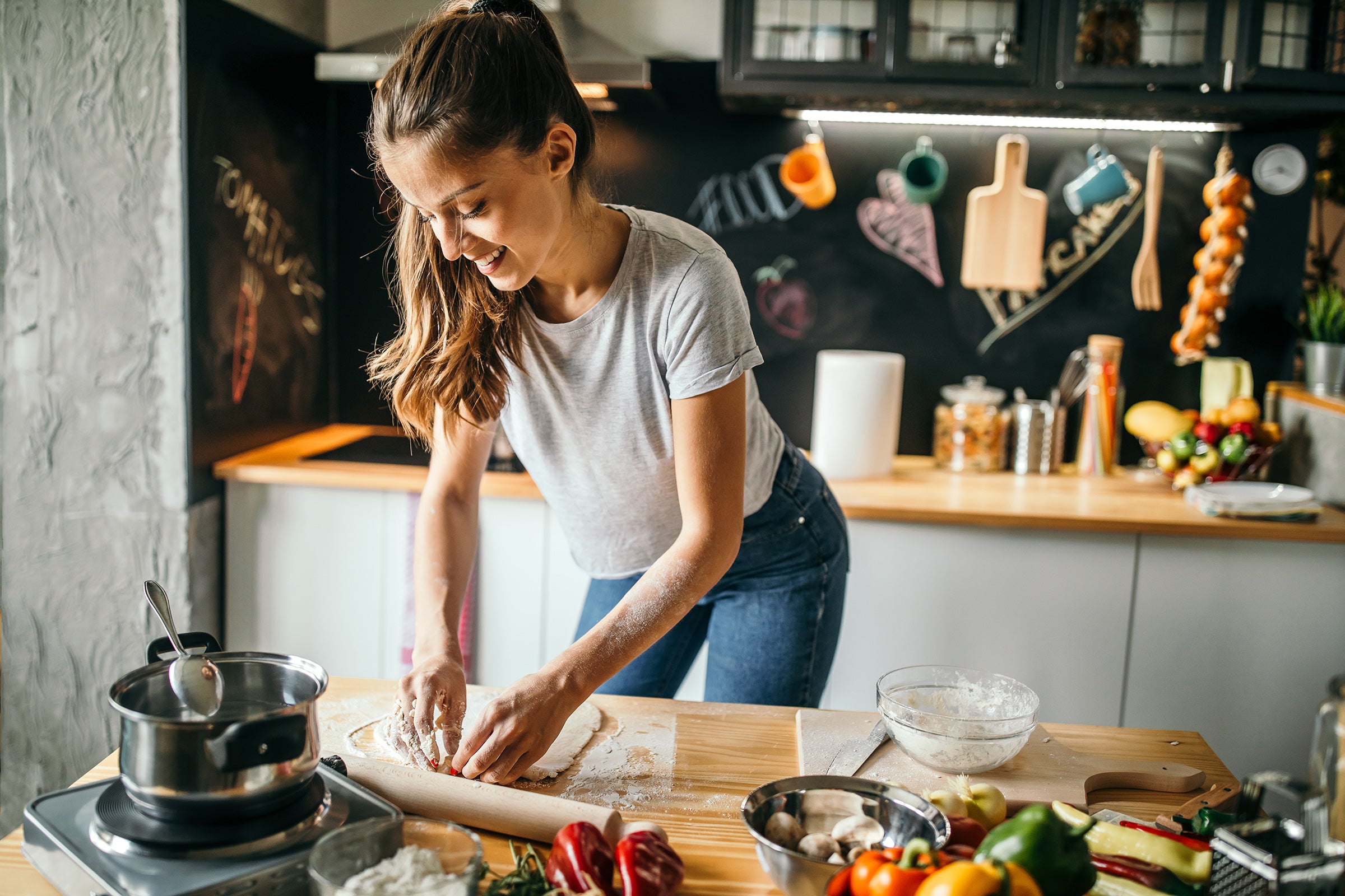 young woman cooking recipes at home