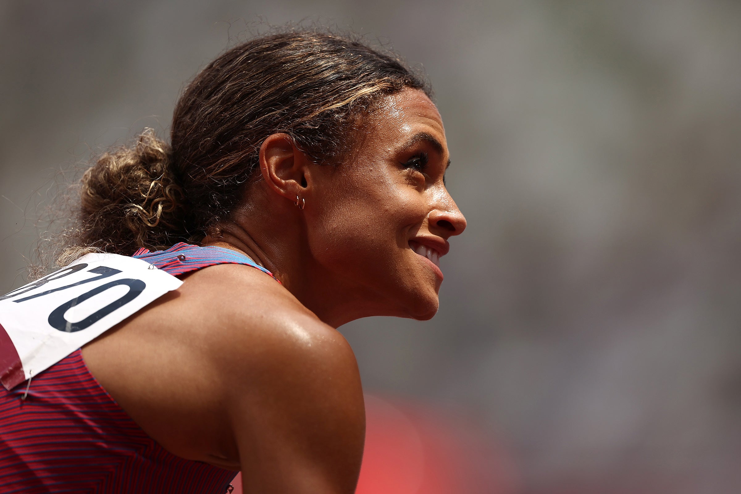 Sydney McLaughlin smiles with her hair pulled back at the 2020 Olympics