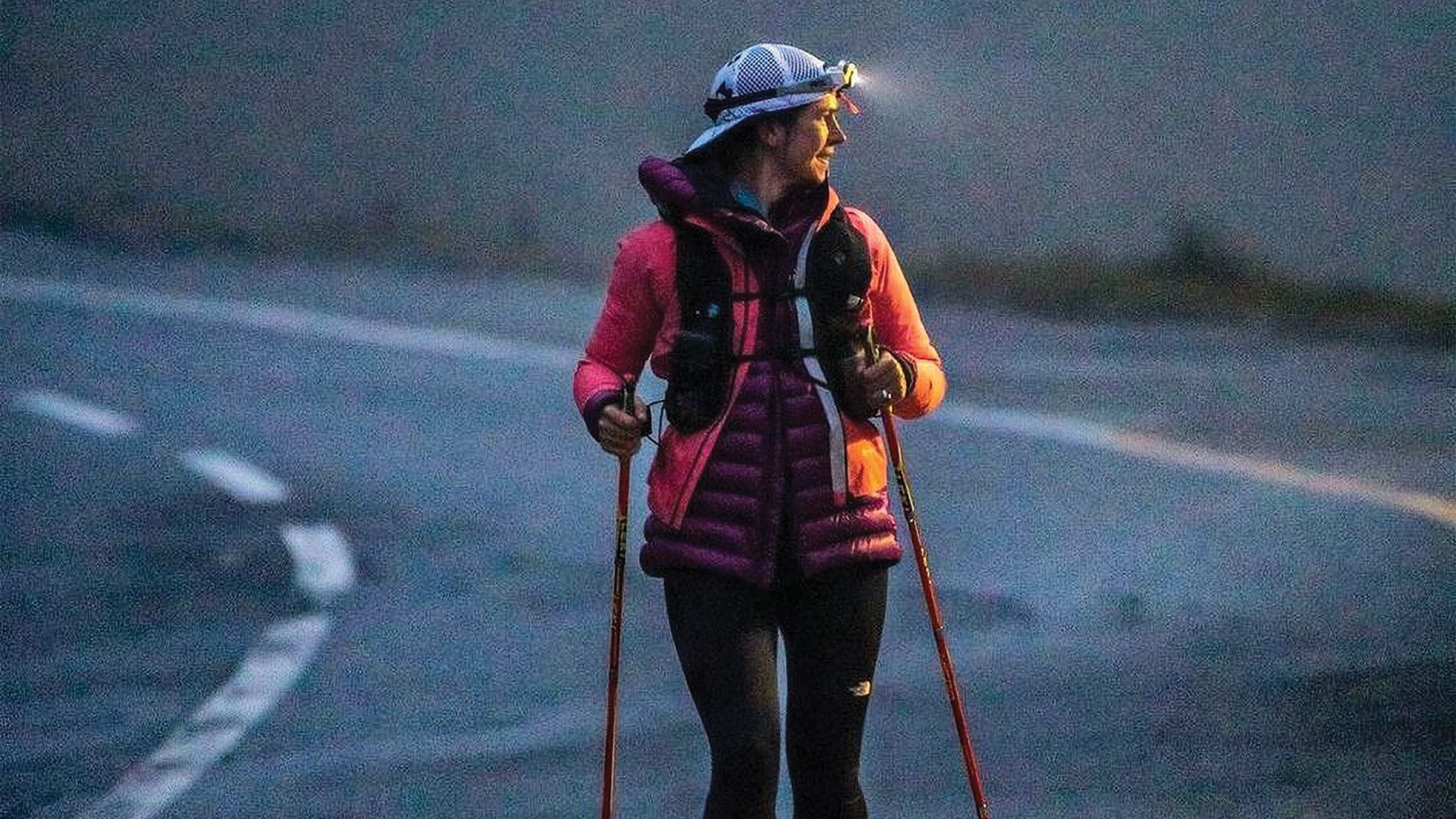 Stephanie Case with hiking poles and a headlamp