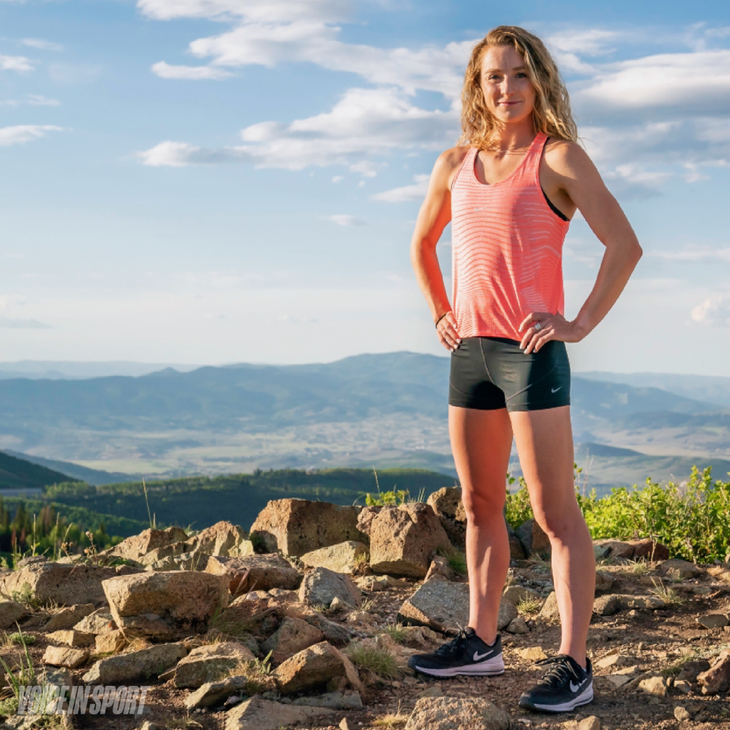 Elise Cranny, athlete mentor for Voice in Sport, supporting girl runners, poses with hands on hips