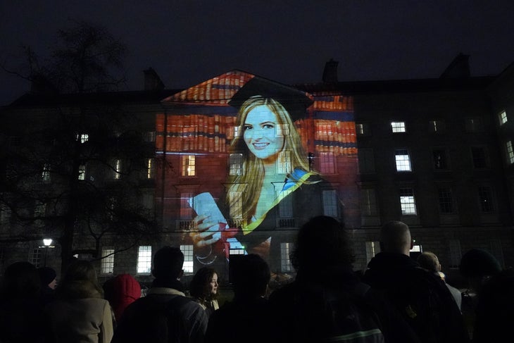 Ashling Murphy photo projected on wall of Trinity College