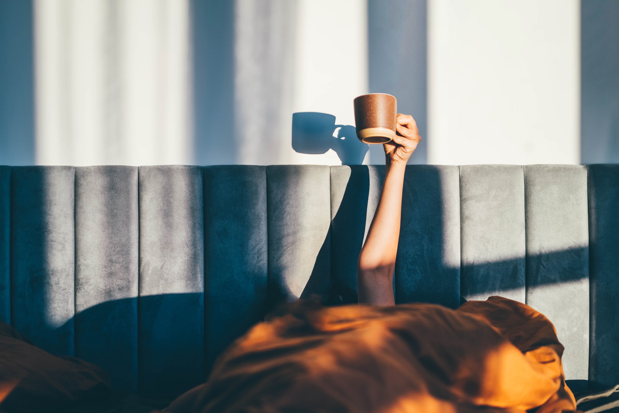 Women holding coffee cup, low on energy
