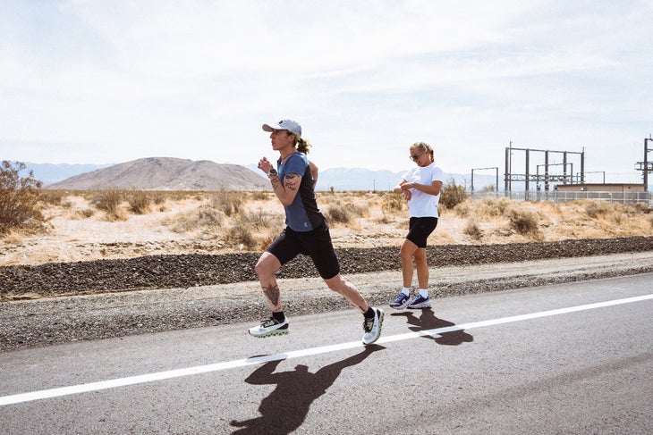 one woman hands a baton to another running the spreed project in the desert