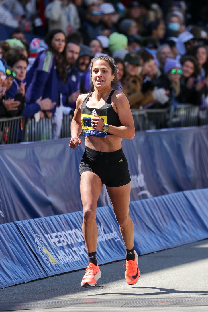 Nell Rojas running to the finish in the 2022 Boston Marathon after breaking her sponsorship