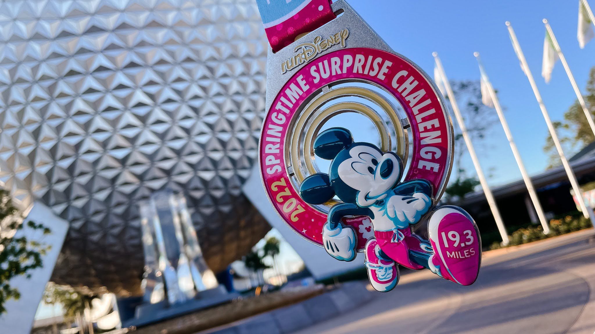 the springtime surprise weekend challenge medal from runDisney in front of EPCOT