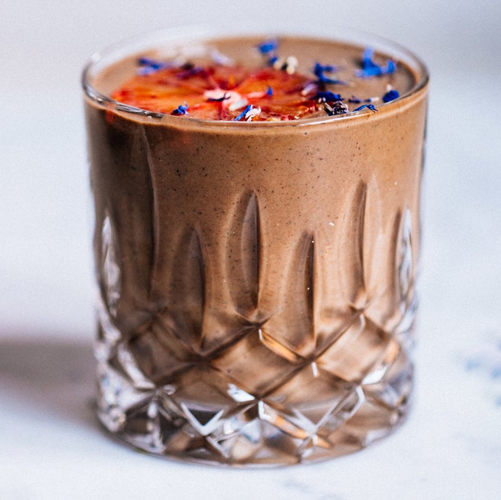 chocolate smoothie in a glass that uses adaptogenic ingredients