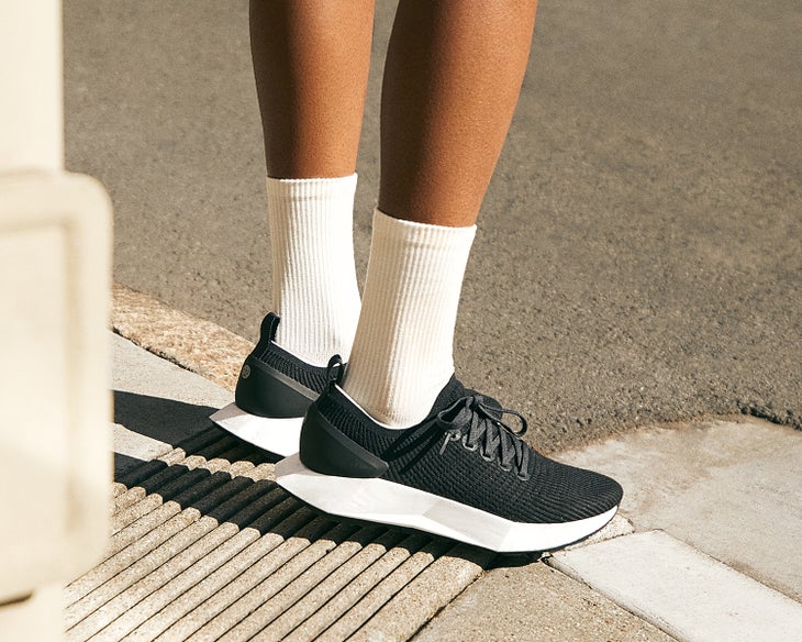close-up of a dark-skinned women's feet wearing the new Allbirds Flyer