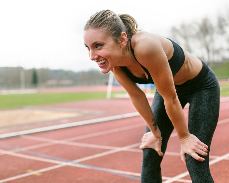 athlete woman recovering after training, smiling after turning micro-quits into micro-commitments