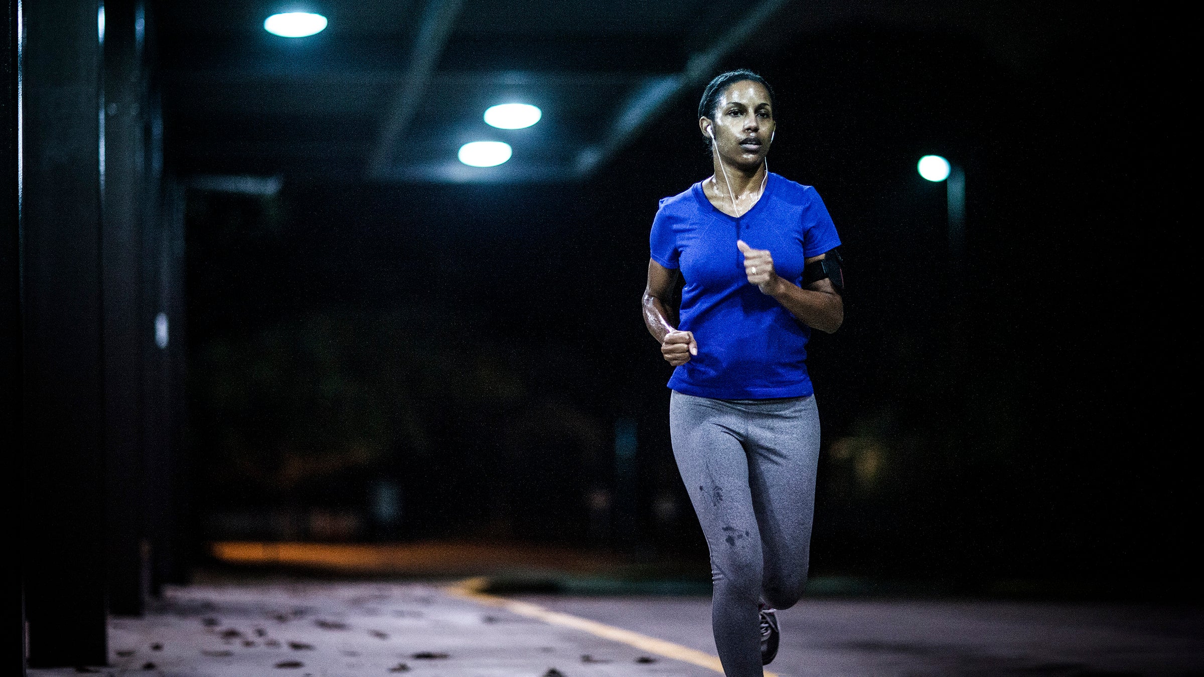 sweaty woman running at night