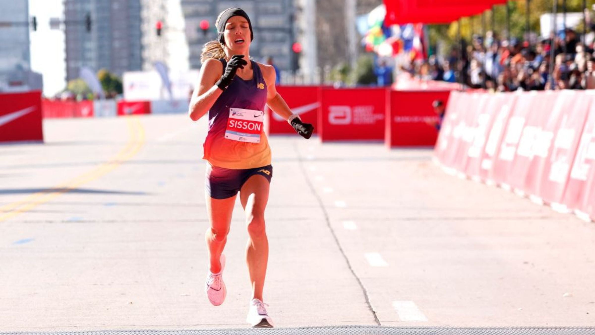 Emily Sisson of the United States crosses the finish line to finish second place in the women's professional division of the 2022 Chicago Marathon, breaking the American record for the 26.2 distance