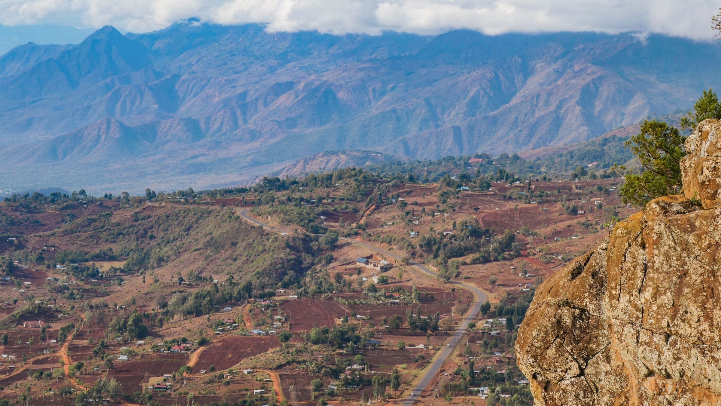 a landscape view of Kenyan highlands with browns and yellow soils and agricultural lands