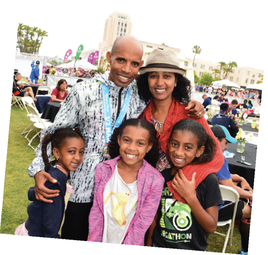 Yordanos Keflezighi and daughters support Meb after he paced a half marathon.