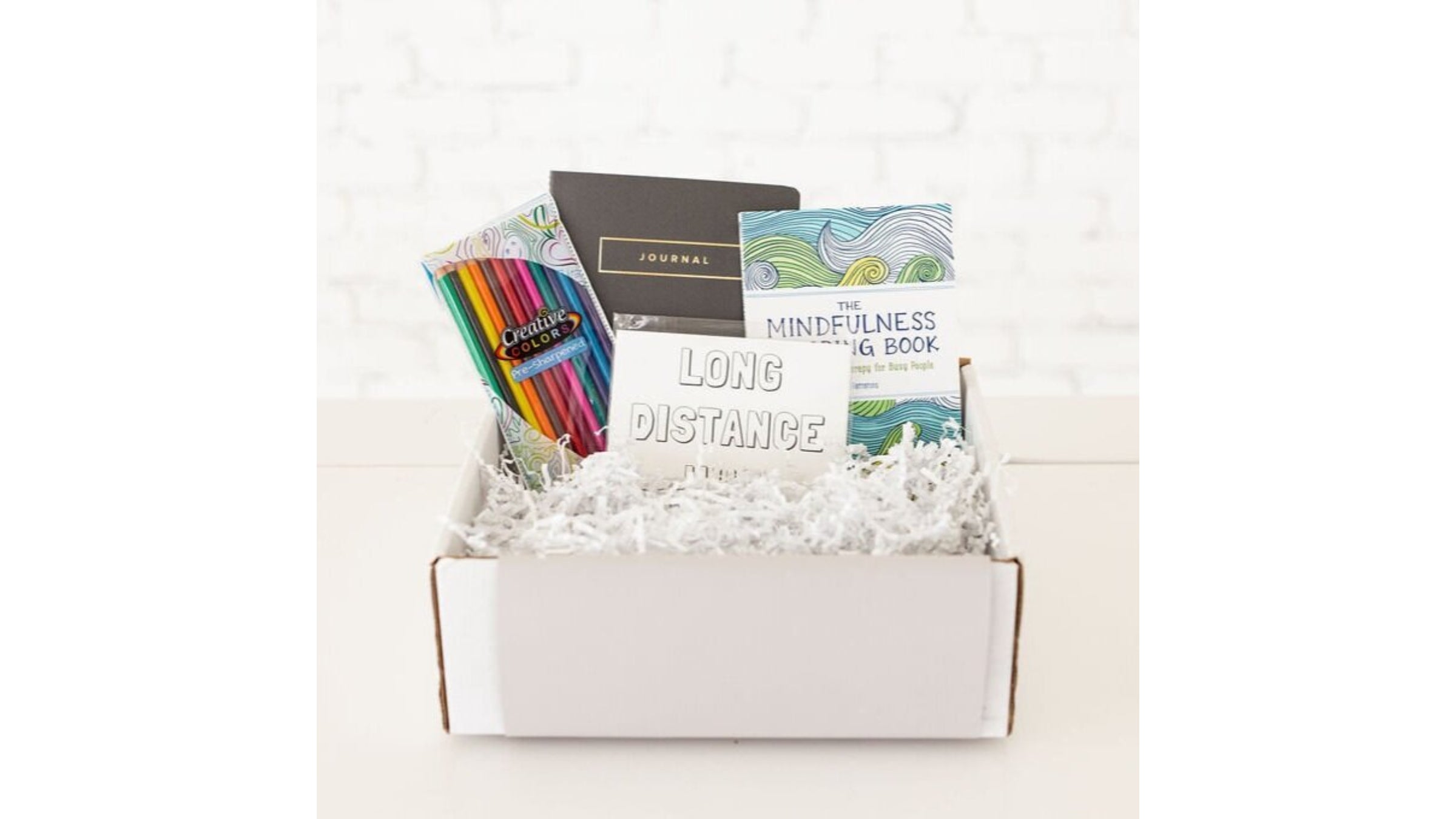 White box with colored pencils and cards